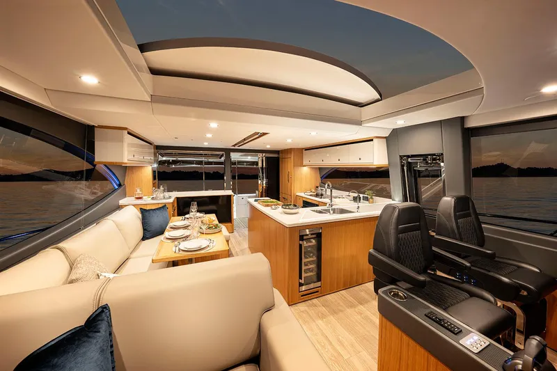 Slide: The Image of Manufacturer Provided Image: Luxurious interior of 2025 Riviera 585 SUV yacht with modern kitchen and seating area. - 47