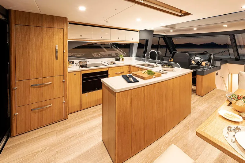Slide: The Image of Manufacturer Provided Image: Luxurious interior of 2025 Riviera 585 SUV yacht with modern kitchen and dining area. - 48