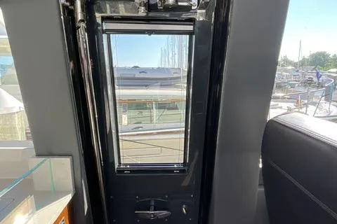 Slide: The Image of Interior view of 2025 Riviera 585 SUV yacht, showcasing sleek design and marina backdrop. - 5
