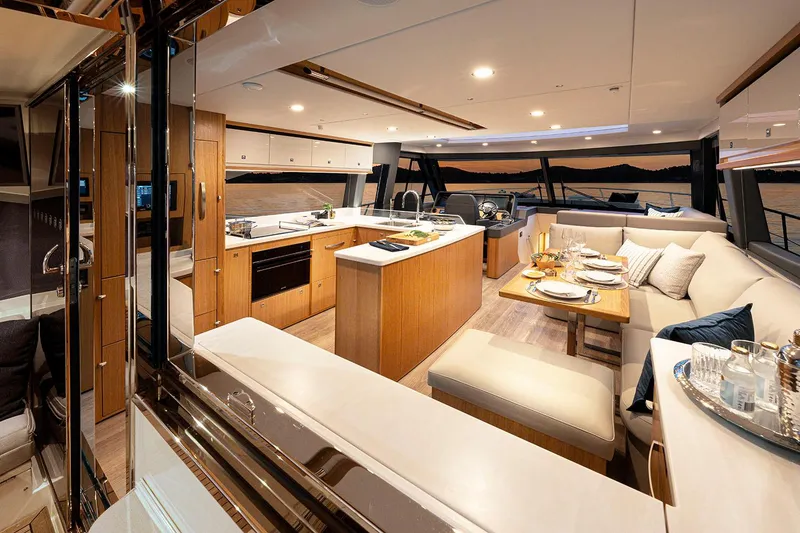 Slide: The Image of Manufacturer Provided Image: Luxurious interior of 2025 Riviera 585 SUV yacht with modern kitchen and dining area. - 50