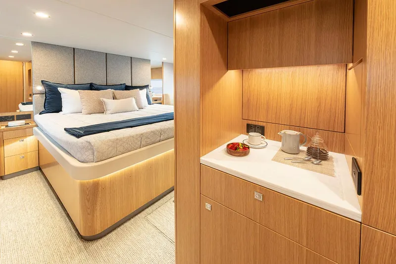 Slide: The Image of Manufacturer Provided Image: Luxurious interior of 2025 Riviera 585 SUV yacht with elegant bedroom and kitchenette. - 54