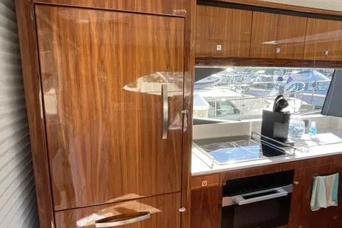 Slide: The Image of Luxurious interior of 2025 Riviera 585 SUV yacht with sleek wooden cabinetry. - 8