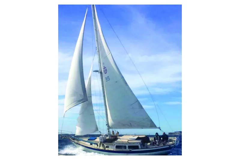 The Image of 1976 Down East Yachts Inc Cutter sailing on open water under clear blue skies. - 1