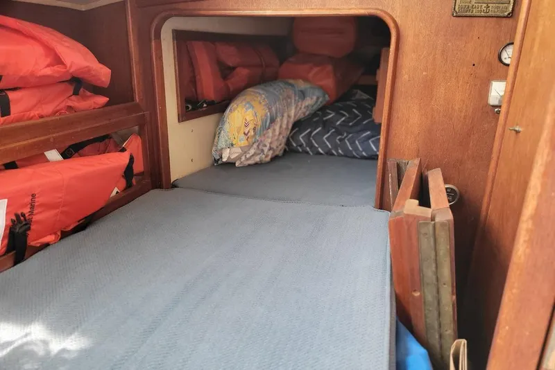 Slide: The Image of Cozy cabin interior of 1976 Down East Yachts Cutter with life jackets and bedding. - 24
