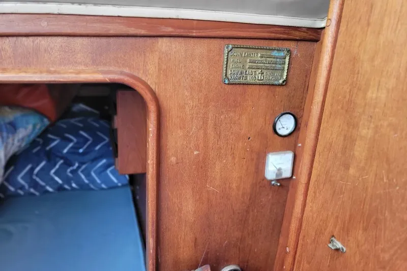 Slide: The Image of 1976 Down East Yachts Inc Cutter interior with wood paneling and gauges. - 25