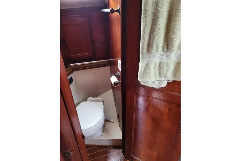 Slide: The Image of 1976 Down East Yachts Cutter bathroom with wooden interior and compact toilet. - 30