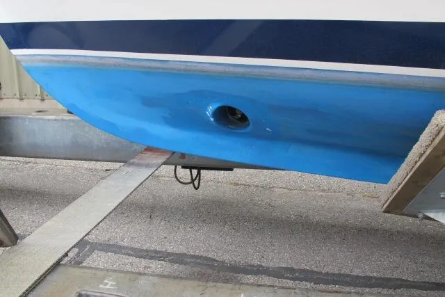 Slide: The Image of 2010 Ellis Downeast Picnic Boat docked in a marina, featuring a sleek white design. - 1