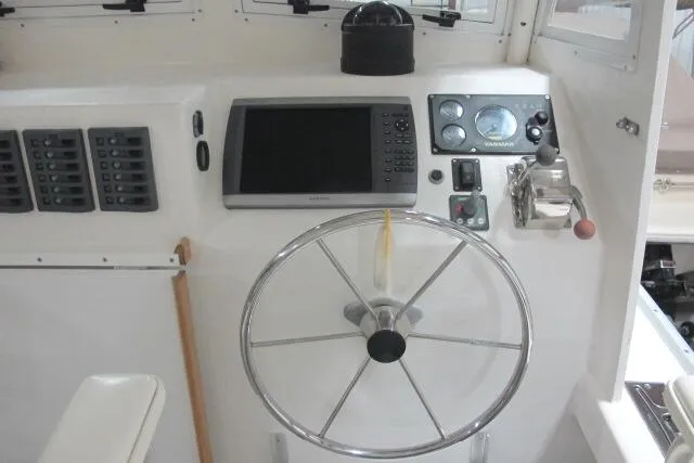 Slide: The Image of 2010 Ellis Downeast Picnic Boat interior with cozy cabin, sink, and storage. - 6