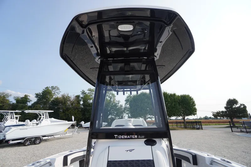 Slide: The Image of 2026 Tidewater 210 LXF boat with sleek black T-top and modern design. - 10
