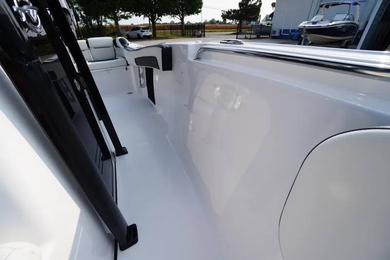 Slide: The Image of 2026 Tidewater 210 LXF boat interior with sleek white design and seating. - 14