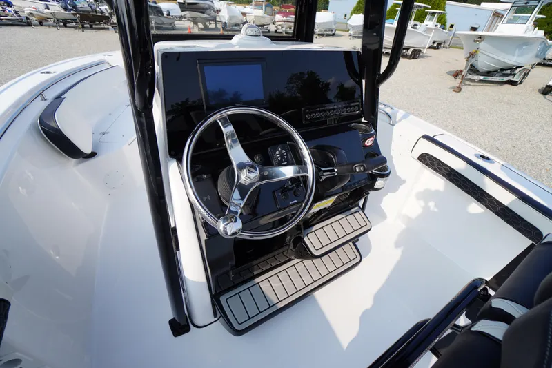 Slide: The Image of 2026 Tidewater 210 LXF boat dashboard with steering wheel and controls. - 17