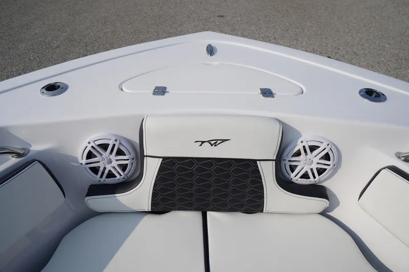 Slide: The Image of 2026 Tidewater 210 LXF boat interior with cushioned seating and built-in speakers. - 2