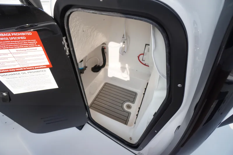 Slide: The Image of Open hatch of 2026 Tidewater 210 LXF boat showing interior storage space. - 21