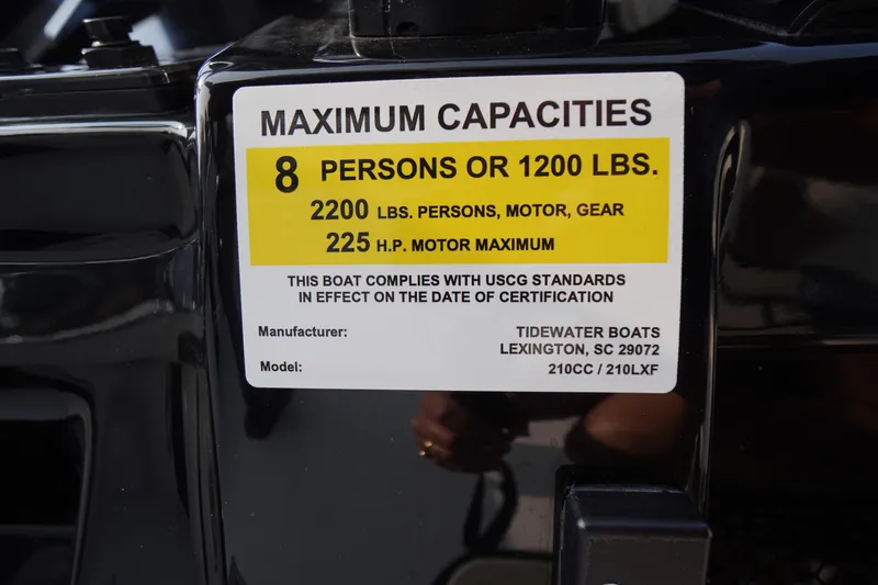 Slide: The Image of Sticker on Tidewater 210 LXF boat showing maximum capacities and compliance details. - 23