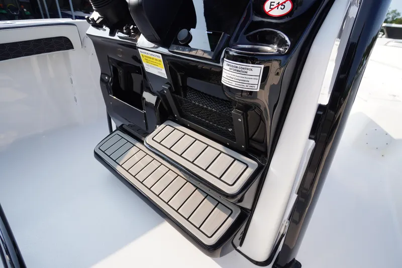 Slide: The Image of 2026 Tidewater 210 LXF boat steps with emission control information label. - 25