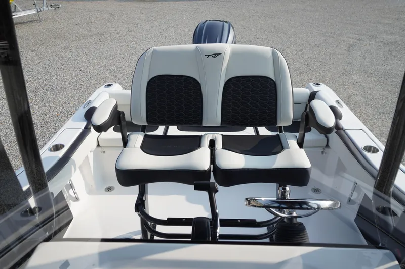 Slide: The Image of 2026 Tidewater 210 LXF boat interior with dual seating and steering wheel. - 28