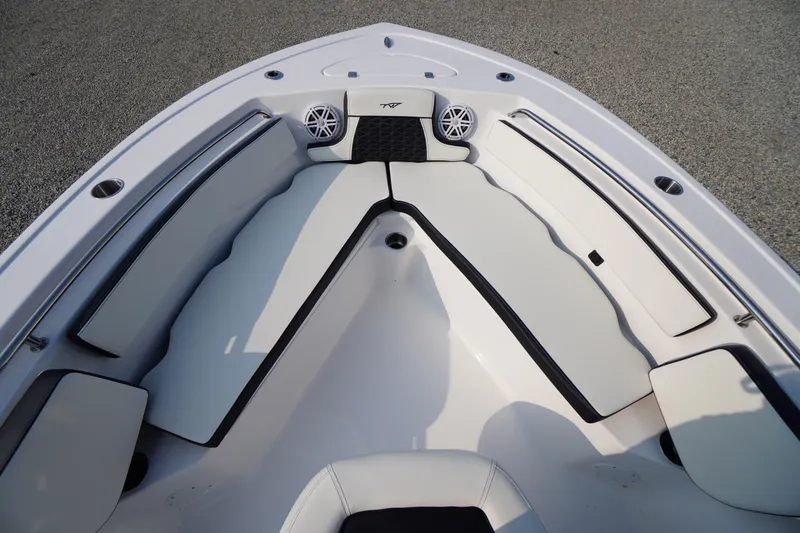 Slide: The Image of 2026 Tidewater 210 LXF boat interior with cushioned seating and speaker system. - 3