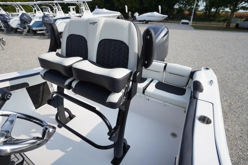 Slide: The Image of 2026 Tidewater 210 LXF boat interior with dual seats and steering wheel. - 31
