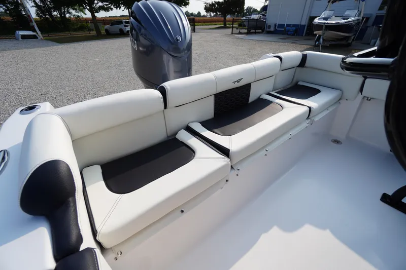 Slide: The Image of 2026 Tidewater 210 LXF boat interior with cushioned seating and outboard motor. - 35