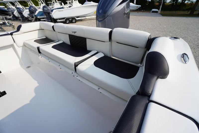 Slide: The Image of 2026 Tidewater 210 LXF boat interior with cushioned seating and modern design. - 36
