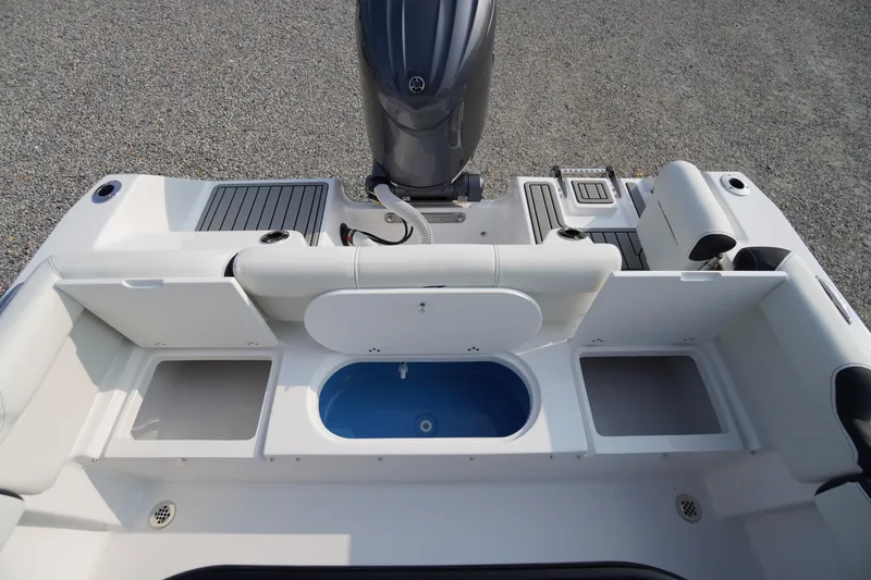 Slide: The Image of 2026 Tidewater 210 LXF boat interior with storage compartments and motor. - 39