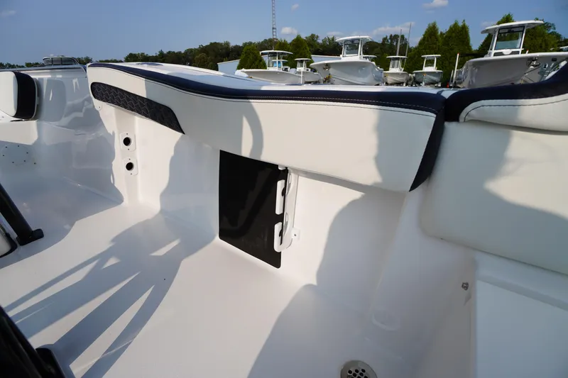 Slide: The Image of 2026 Tidewater 210 LXF boat interior with sleek seating and storage compartment. - 44