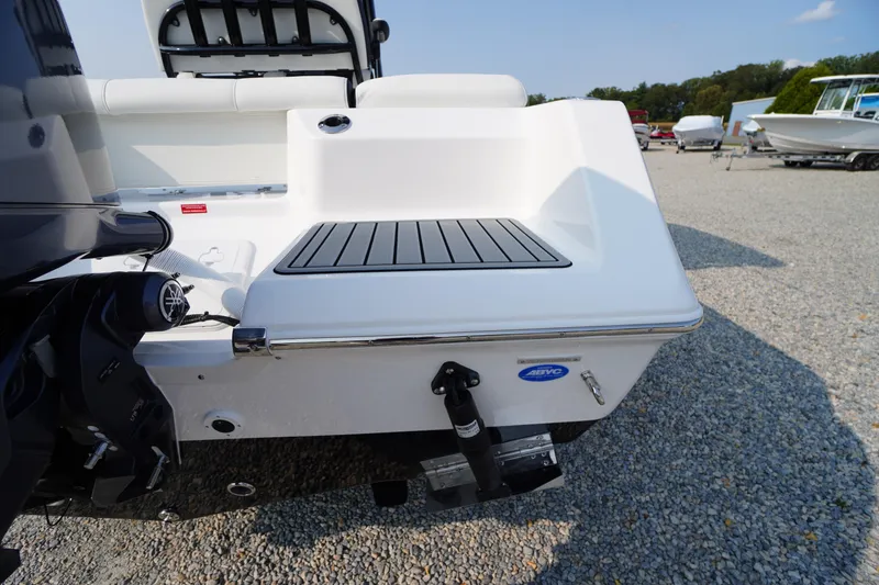 Slide: The Image of 2026 Tidewater 210 LXF boat stern with motor and swim platform on gravel. - 52