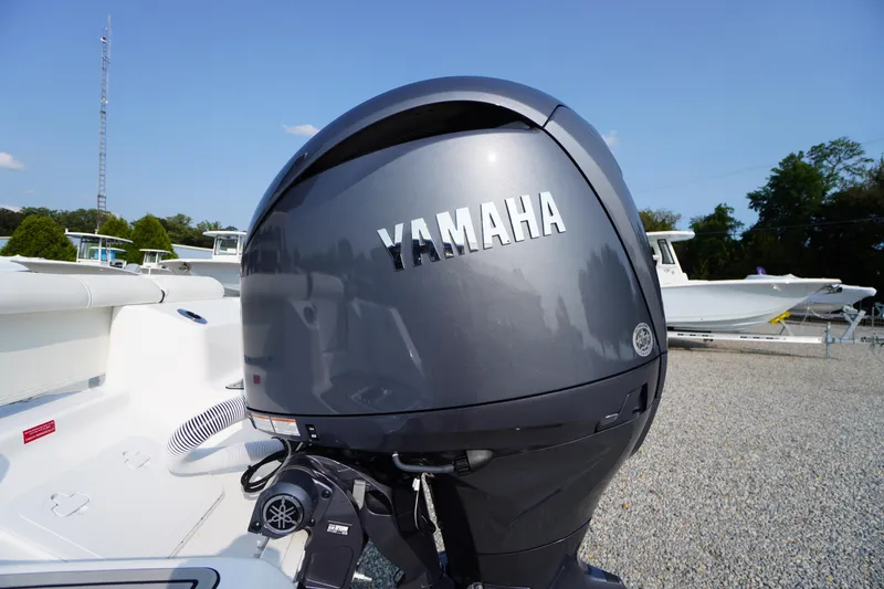 Slide: The Image of Yamaha outboard motor on 2026 Tidewater 210 LXF boat, parked on gravel lot. - 53