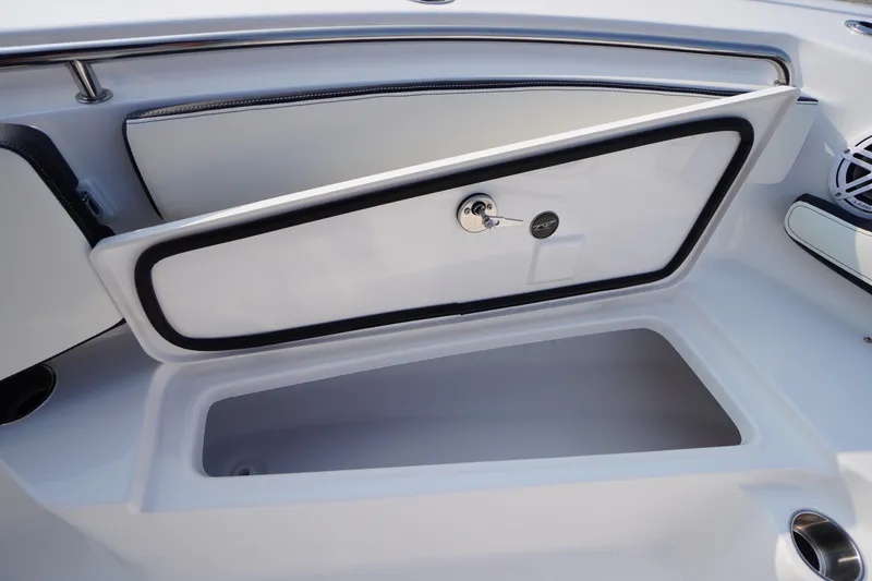Slide: The Image of 2026 Tidewater 210 LXF boat storage compartment with open lid and secure lock. - 7