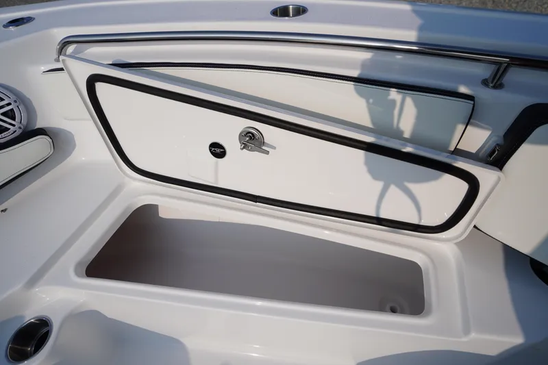 Slide: The Image of 2026 Tidewater 210 LXF boat storage compartment with open hatch and sleek design. - 8