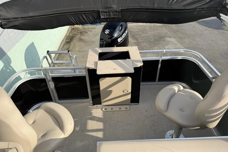 Slide: The Image of 2025 Avalon VTX Quad Fish boat interior with seating and Suzuki outboard motor. - 5