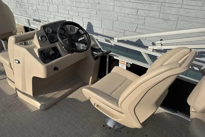 Slide: The Image of 2025 Avalon VTX Quad Fish boat interior with beige captain's chair and steering console. - 7