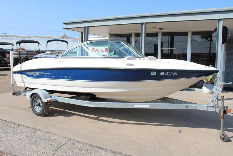The Image of 2009 Bayliner 175 GT boat on trailer, parked outside a building. - 1