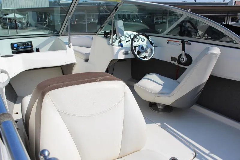 Slide: The Image of Interior of a 2009 Bayliner 175 GT boat with white seating and steering wheel. - 11