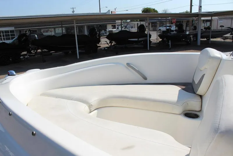 Slide: The Image of 2009 Bayliner 175 GT boat interior with white seating and cup holder. - 14