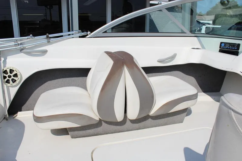 Slide: The Image of 2009 Bayliner 175 GT boat interior with white and brown seating, speaker, and control panel. - 9