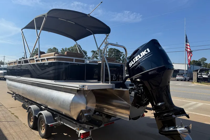 Slide: The Image of 2026 Avalon VENTURE QUAD LOUNGER pontoon boat with Suzuki outboard motor on trailer. - 7