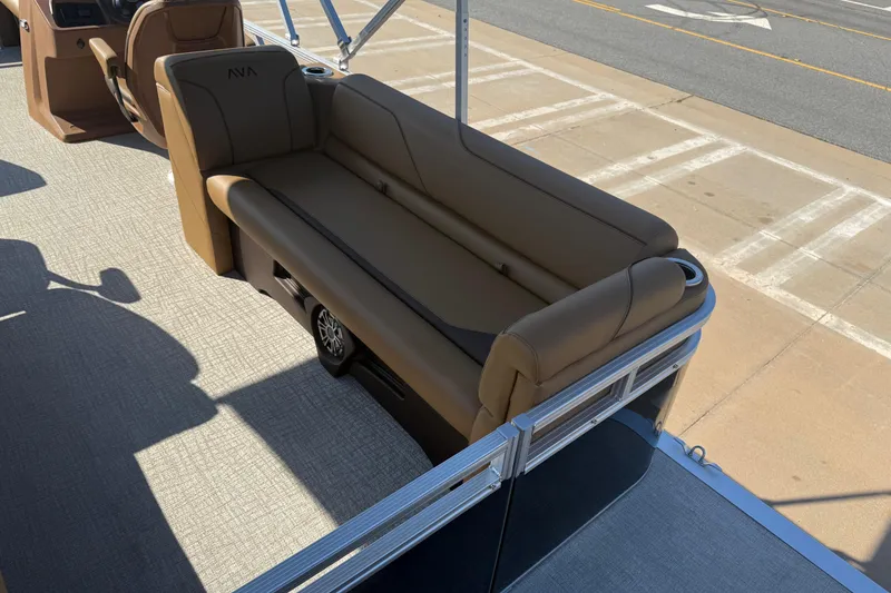 Slide: The Image of 2026 Avalon VENTURE QUAD LOUNGER boat interior with brown seating and cup holders. - 16