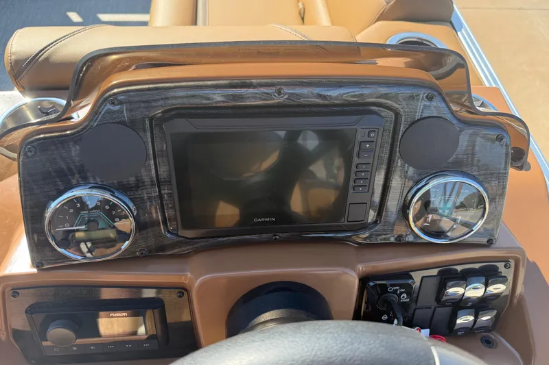 Slide: The Image of Dashboard of 2026 Avalon VENTURE QUAD LOUNGER with Garmin display and controls. - 22