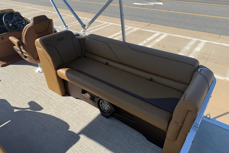 Slide: The Image of 2026 Avalon VENTURE QUAD LOUNGER boat interior with brown seating and steering console. - 14