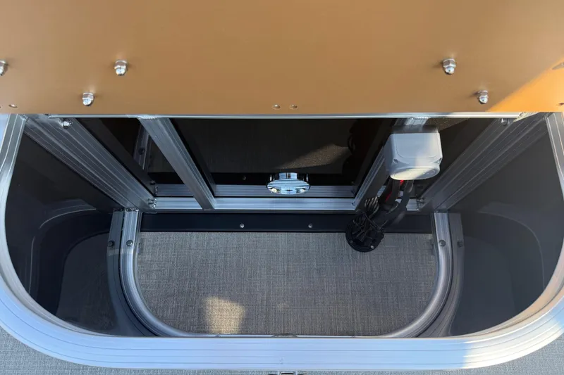 Slide: The Image of 2026 Avalon VENTURE QUAD LOUNGER storage compartment with metal frame and wiring. - 20