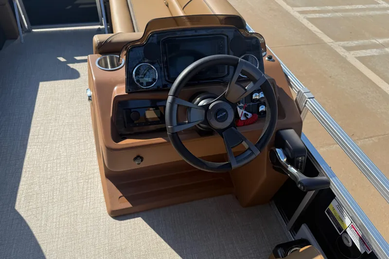 Slide: The Image of Steering console of 2026 Avalon VENTURE QUAD LOUNGER pontoon boat, featuring modern controls. - 21