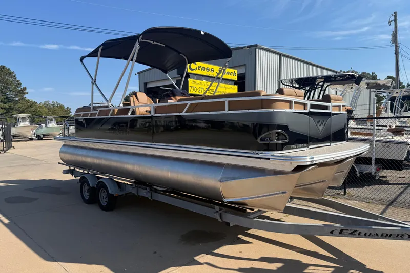 The Image of 2026 Avalon VENTURE QUAD LOUNGER pontoon boat on trailer, outdoor dealership display. - 0