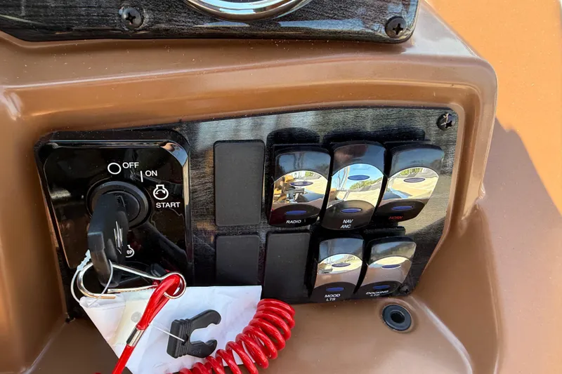 Slide: The Image of Control panel of 2026 Avalon VENTURE QUAD LOUNGER with ignition and switches. - 24