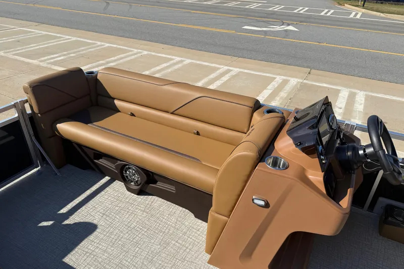 Slide: The Image of 2026 Avalon VENTURE QUAD LOUNGER boat interior with tan seating and steering console. - 10