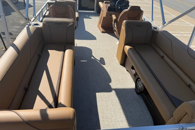 Slide: The Image of 2026 Avalon VENTURE QUAD LOUNGER interior with brown seating and steering console. - 15