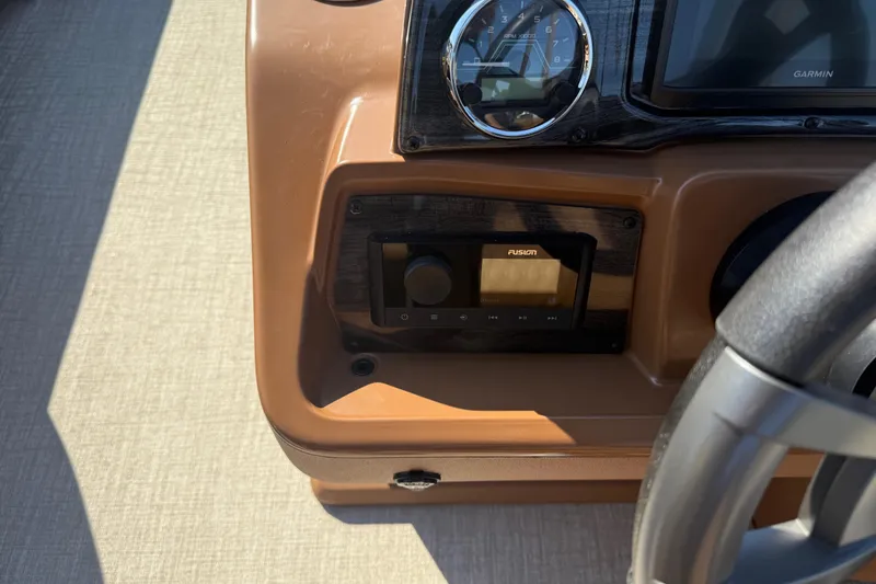 Slide: The Image of 2026 Avalon VENTURE QUAD LOUNGER dashboard with Fusion audio system and RPM gauge. - 23