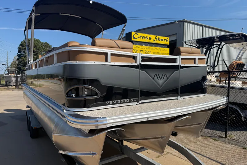 Slide: The Image of 2026 Avalon VENTURE QUAD LOUNGER pontoon boat on trailer, outdoor display. - 2