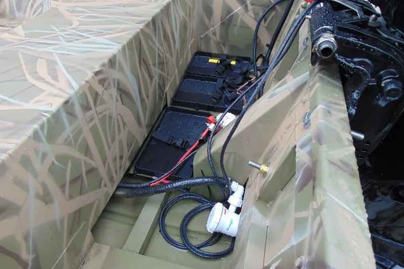 Slide: The Image of Interior view of 2026 CRESTLINIER 1860 Retriever Deluxe Tiller boat with battery setup. - 11