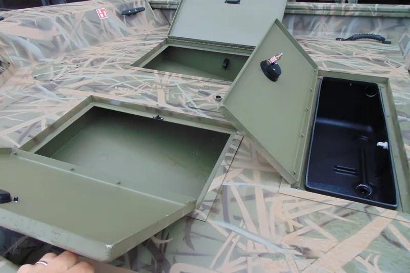 Slide: The Image of 2026 CRESTLINIER 1860 Retriever Deluxe Tiller boat storage compartments open, showcasing interior features. - 13